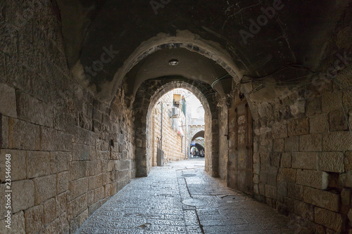 The quiet streets of Jerusalem. The tunnel under the houses on Maronites Monastery street in old city of Jerusalem, Israel photo