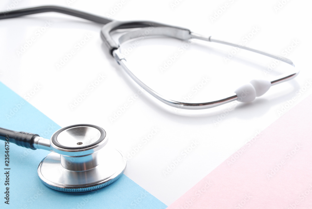 Stethoscope on white. Stethoscope on blue and pink background. Traditional stethoscope. Stethoscope on white. Stethoscope on blue and pink background. Traditional stethoscope.