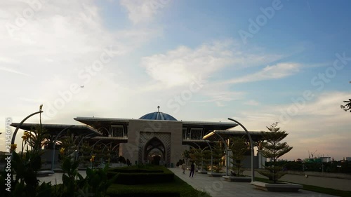 Beautiful sunset time lapse view of Tuanku Mizan Zainal Abidin Mosque or Iron Mosque by the Putrajaya lake in Putrajaya, Malaysia.Zoom In photo