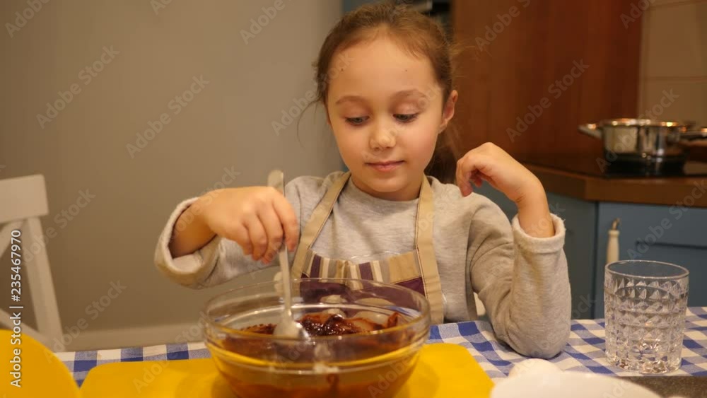 Mother with daughter child at the kitchen together making baking cookies Mother with daughter child at the kitchen together making baking cookies