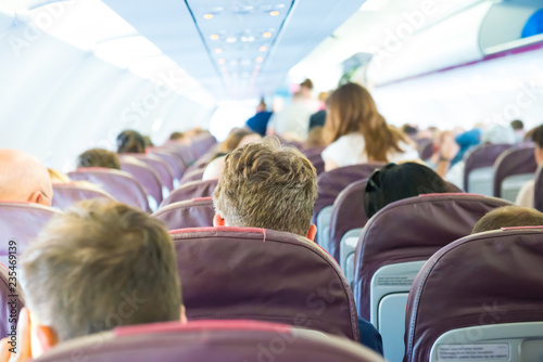 Passengers sit inside airplane - people traveling