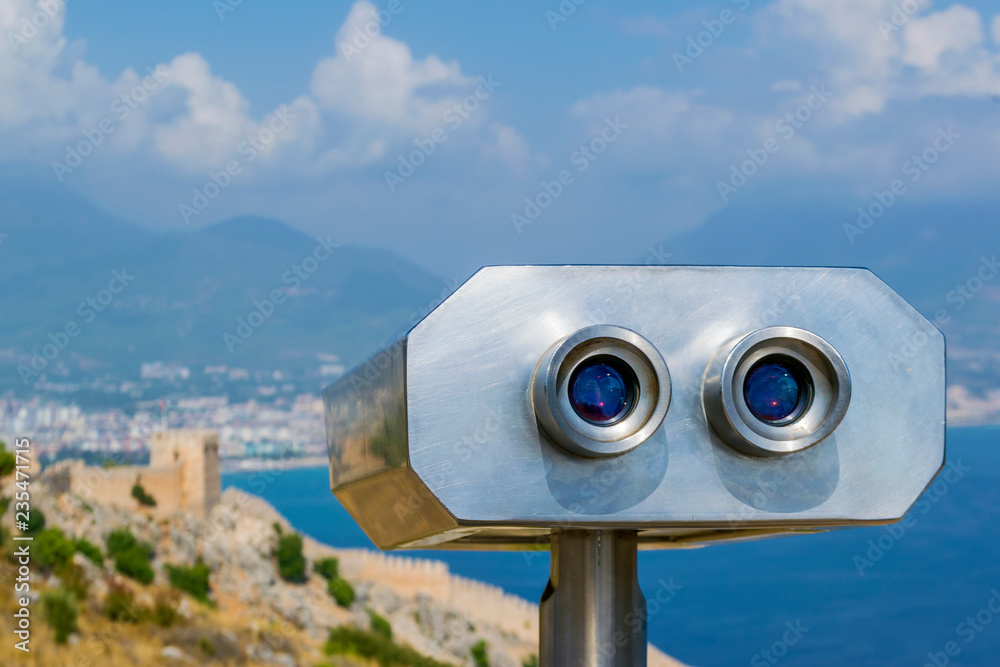 Binocular against the sea and sky. Observation of an ancient fortress.