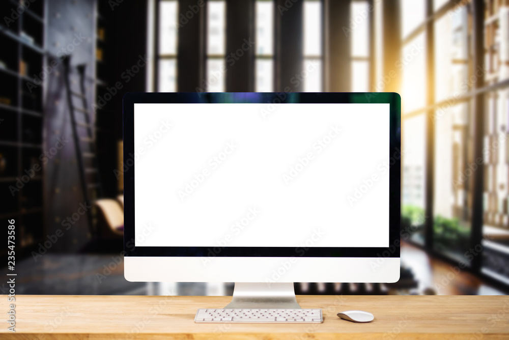 Workspace with computer Monitor, Keyboard, blank screen coffee cup smartphone, and tablet on a table or White Screen Isolated in bright office room interior.