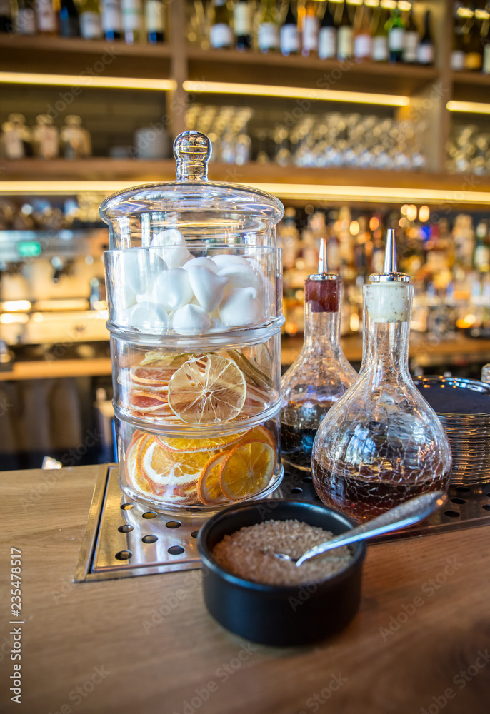 Classic bar counter with bottles in blurred background Classic bar counter with bottles in blurred background
