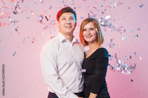 New Year, Saint Valentine's day and holidays concept - happy young people with confetti