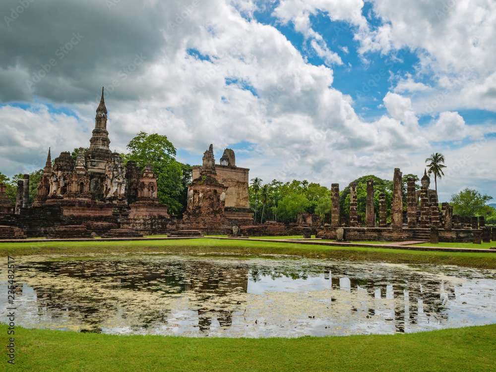 Ruin of ancient Pagoda or stupa reflection in the water in Wat mahathat Temple Area At sukhothai historical park,Sukhothai city Thailand