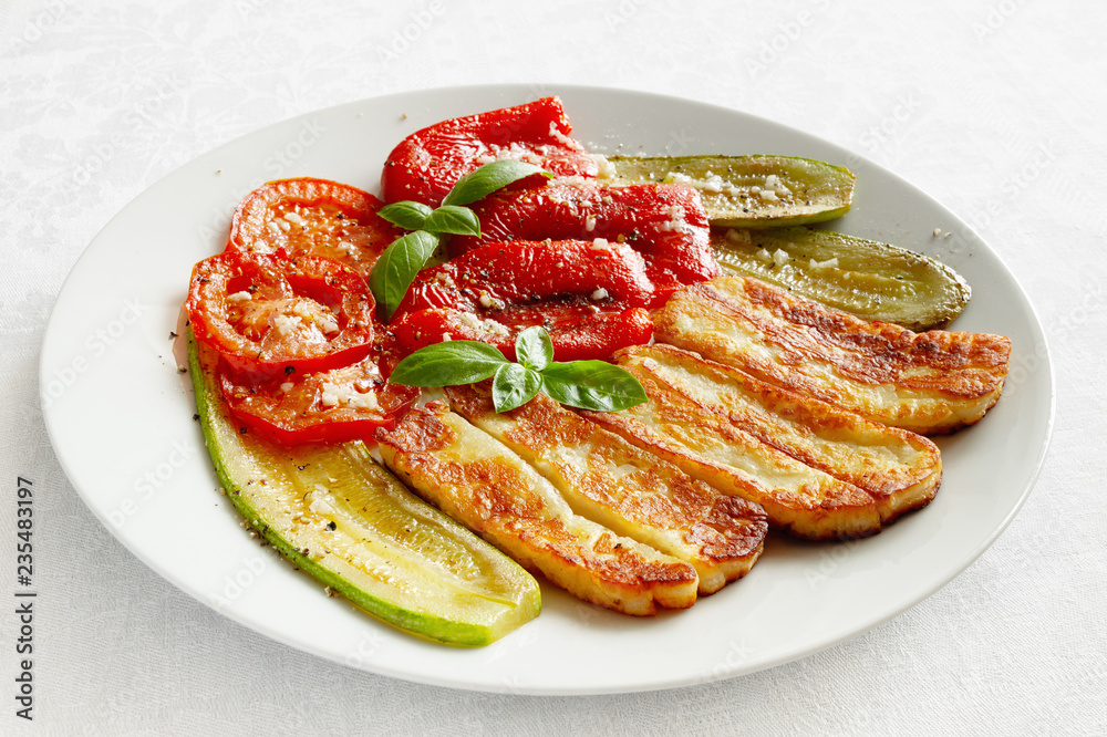 haloumi with roasted vegetables flavoured with olive oil, vinegar, and garlic sprinkled with black pepper and decorated with basil haloumi with roasted vegetables flavoured with olive oil, vinegar, and garlic sprinkled with black pepper and decorated with basil