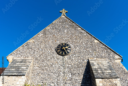 St Margaret's Church, graveyard and cross sign in the village of Rottingdean, East Sussex, England, United Kingdom. photo