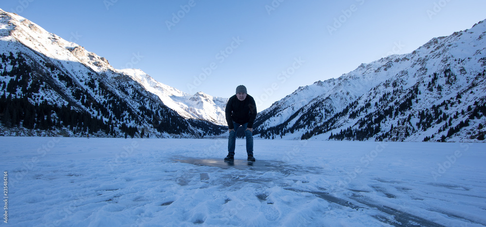 Asian guy in the cold, frozen lake