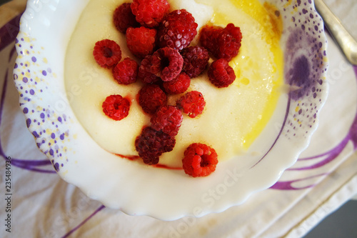 semolina porridge with oil and raspberry. concept of healthy food.