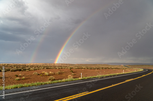 End of a rainbow on red rocks, south west America © Kristian