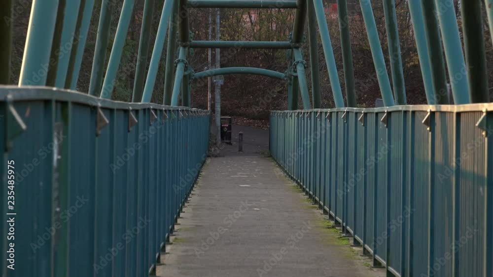 Zoom out along the length of the David Livingstone memorial bridge over the River Clyde in Blantyre, Scotland. Zoom out along the length of the David Livingstone memorial bridge over the River Clyde in Blantyre, Scotland.