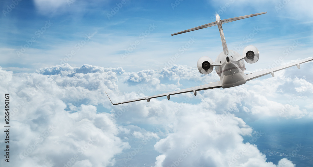 Obraz premium Private jet plane flying above dramatic clouds.