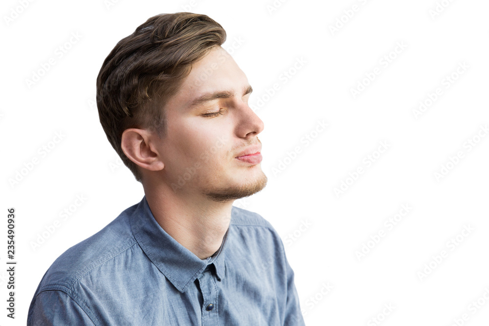 Young man in gray shirt with close eyes on white background. Isolated on white