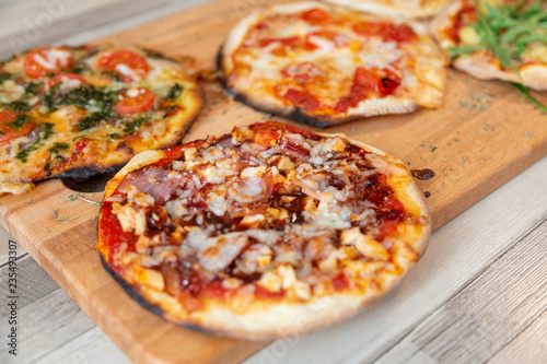close up of barbecue pizza on a wooden board