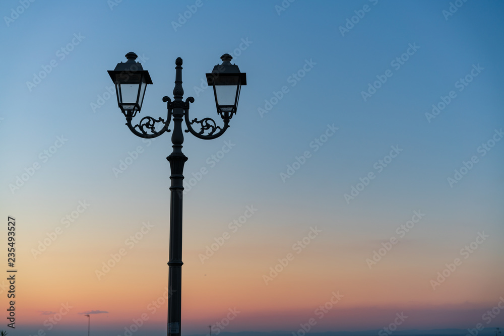 Italian street lamp on blue sky