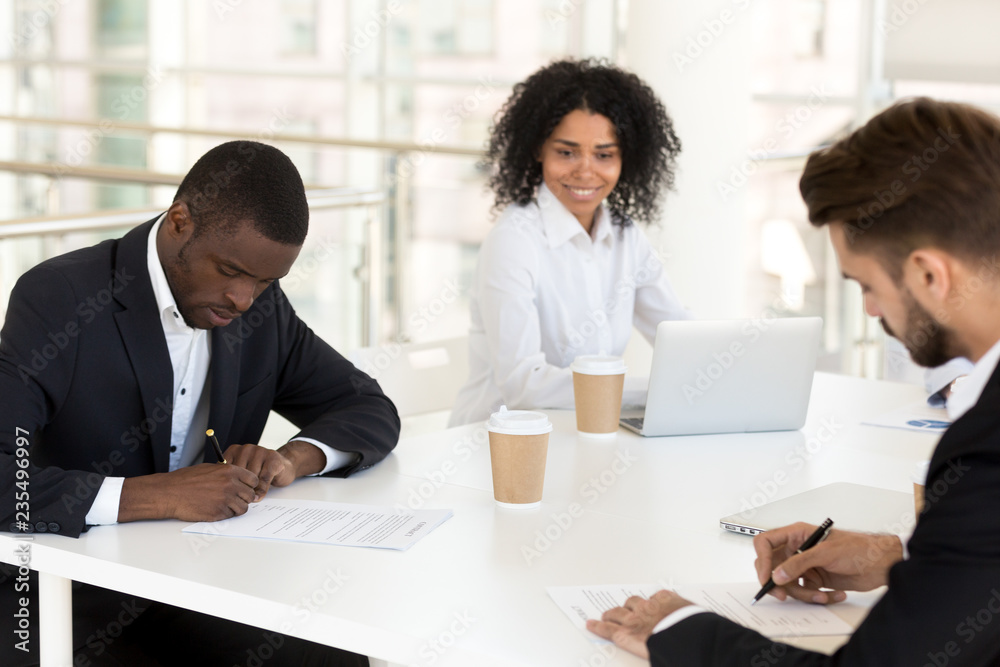 African american and caucasian businessmen signing contracts concept filling form making agreement or collaboration deal at group meeting, new diverse partners put signature on business documents African american and caucasian businessmen signing contracts concept filling form making agreement or collaboration deal at group meeting, new diverse partners put signature on business documents