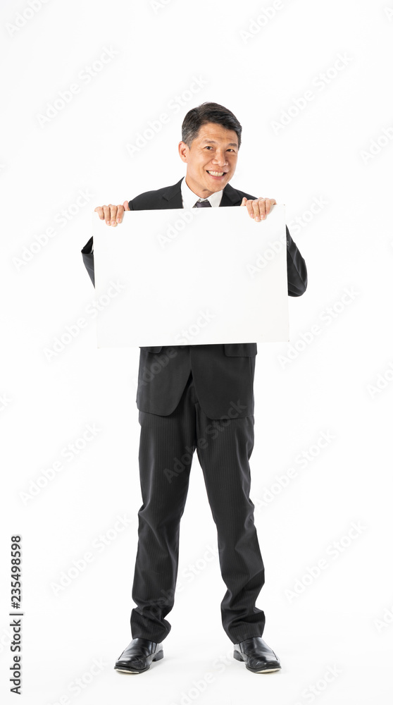 Business man in black suit standing and holding blank banner Business man in black suit standing and holding blank banner