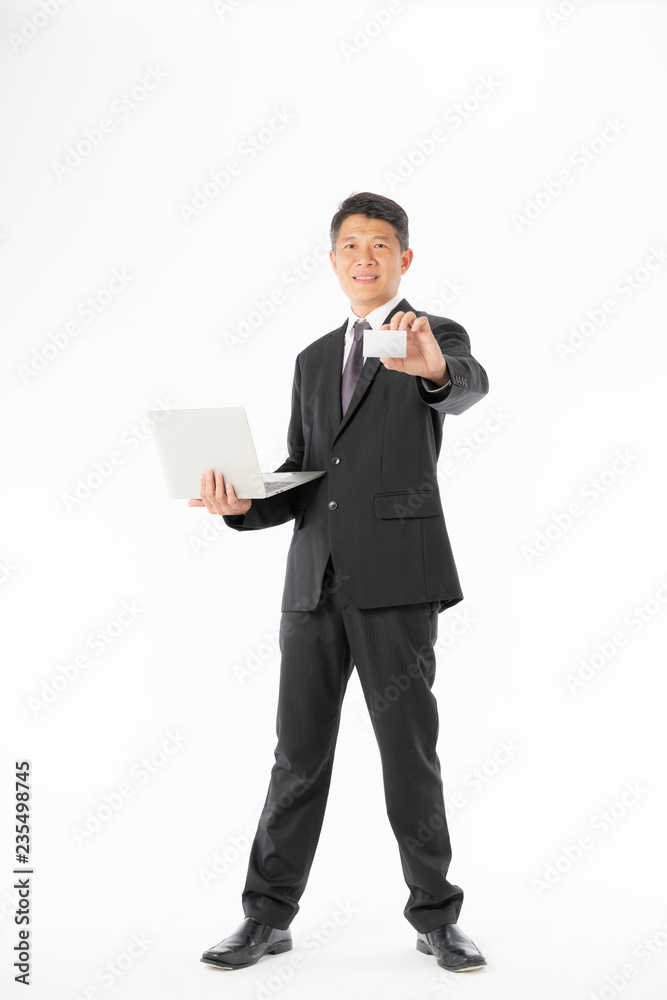 Business man in black suit holding laptop and blank card Business man in black suit holding laptop and blank card