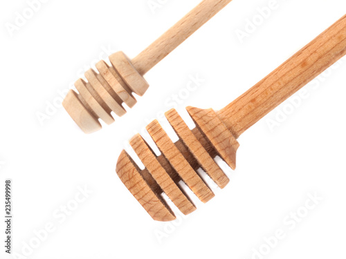 Two wooden honey dippers isolated over white background