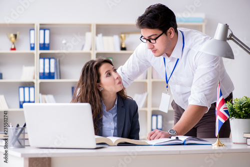 Teacher explaining to student at language training