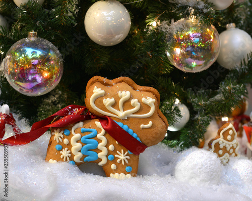 Christmas gingerbread reindeer under holiday tree photo