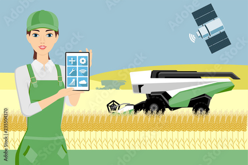 Farmer controls an autonomous combine harvester via satellite. Internet of things in agriculture