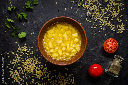 soup anelli pasta and vegetables. Vegan food.  (dark background). top view. copy space photo