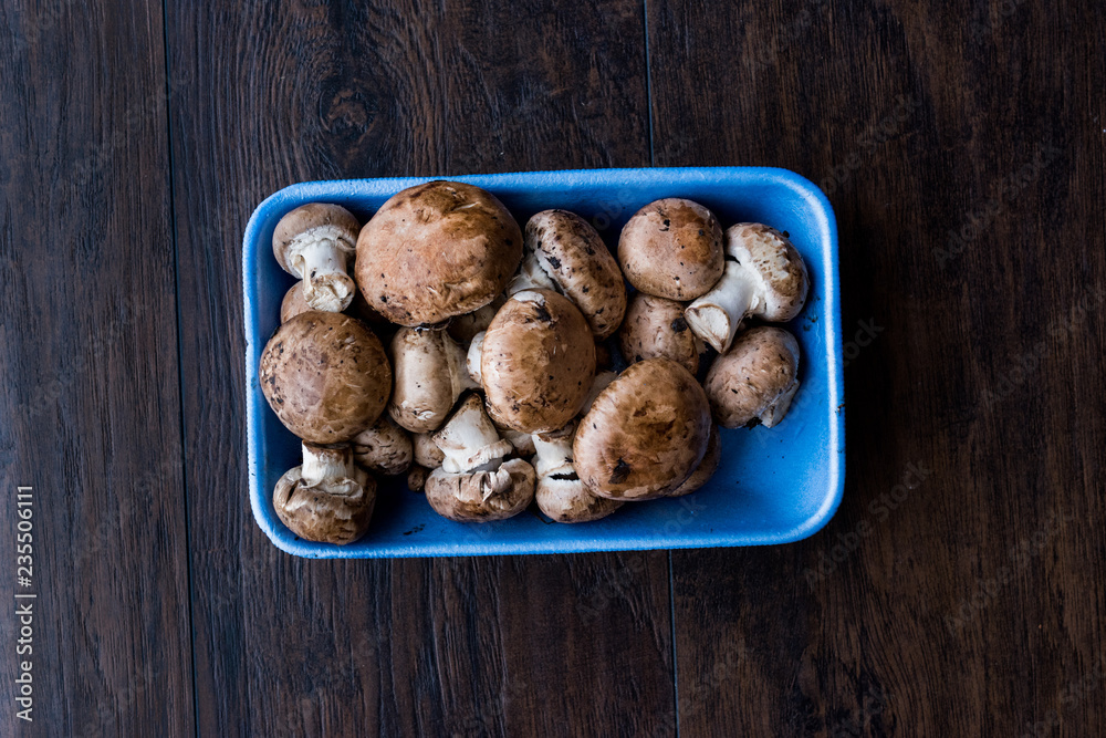 Portobello Raw Cremini Mushrooms in Plastic Container Package or Box. Portobello Raw Cremini Mushrooms in Plastic Container Package or Box.
