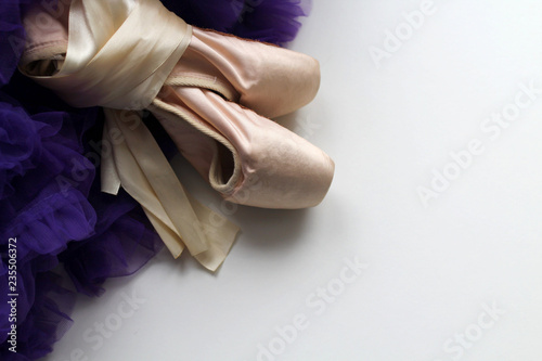 Ballet dance shoes and purple lace skirt with rhyches. Pink satin ribbons. Children's dream