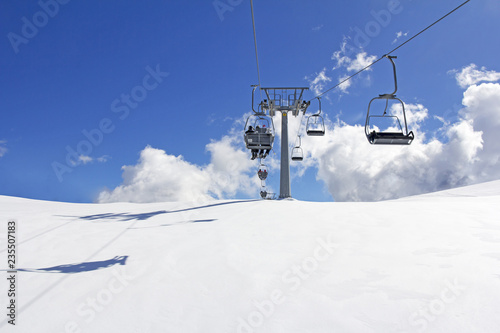 Mountain slopes with Ski lift on a winter sunny day