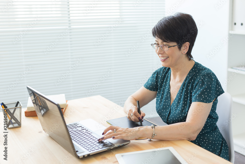 Business, technology and people concept- woman use stylus in working at laptop Business, technology and people concept- woman use stylus in working at laptop