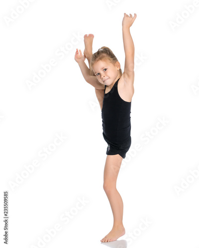 The gymnast balances on one leg.