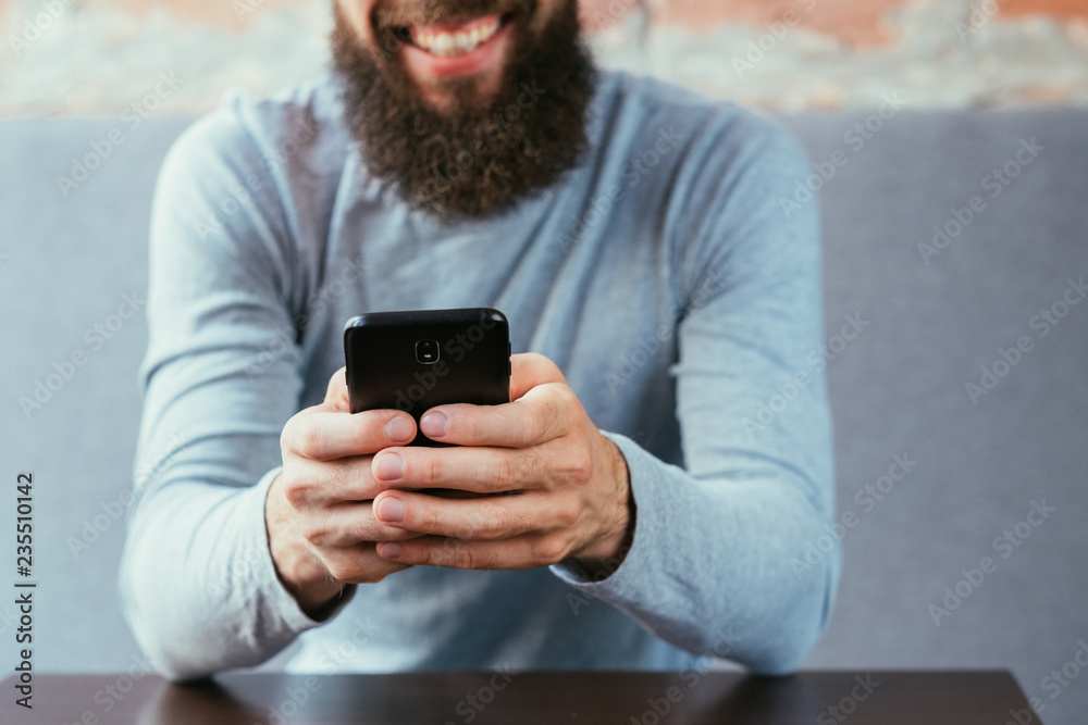 mobile technology and digital device addiction. smiling man holding phone. mobile technology and digital device addiction. smiling man holding phone.