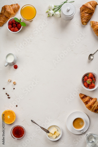 Continental breakfast captured from above - on concrete background photo