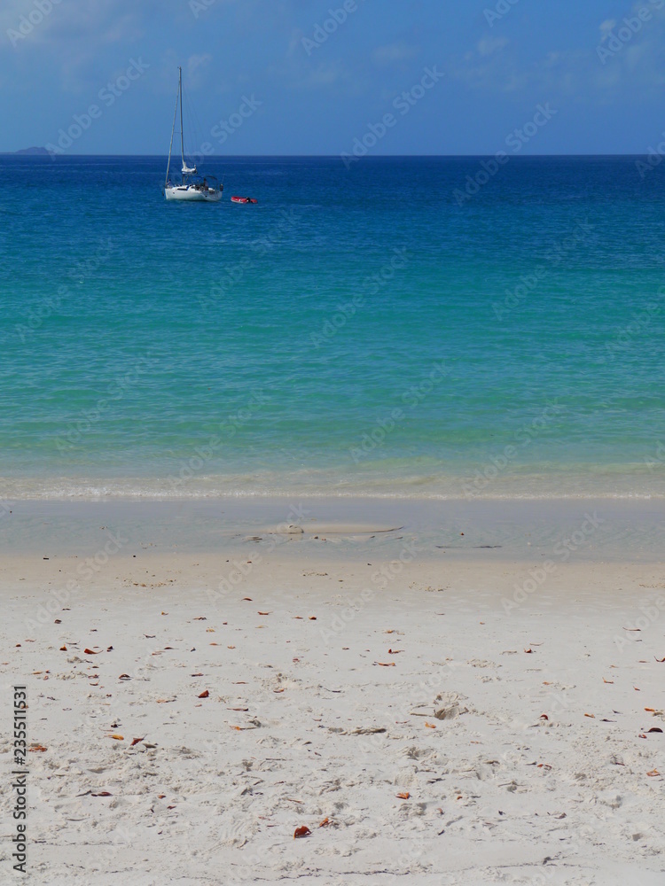 Sailing boat anchoring on Whitehaven Beach, Whitsunday Islands, Australia