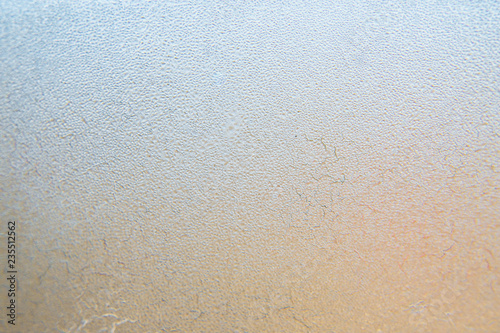 Winter background, frozen glass from strong frost, ice texture on the window