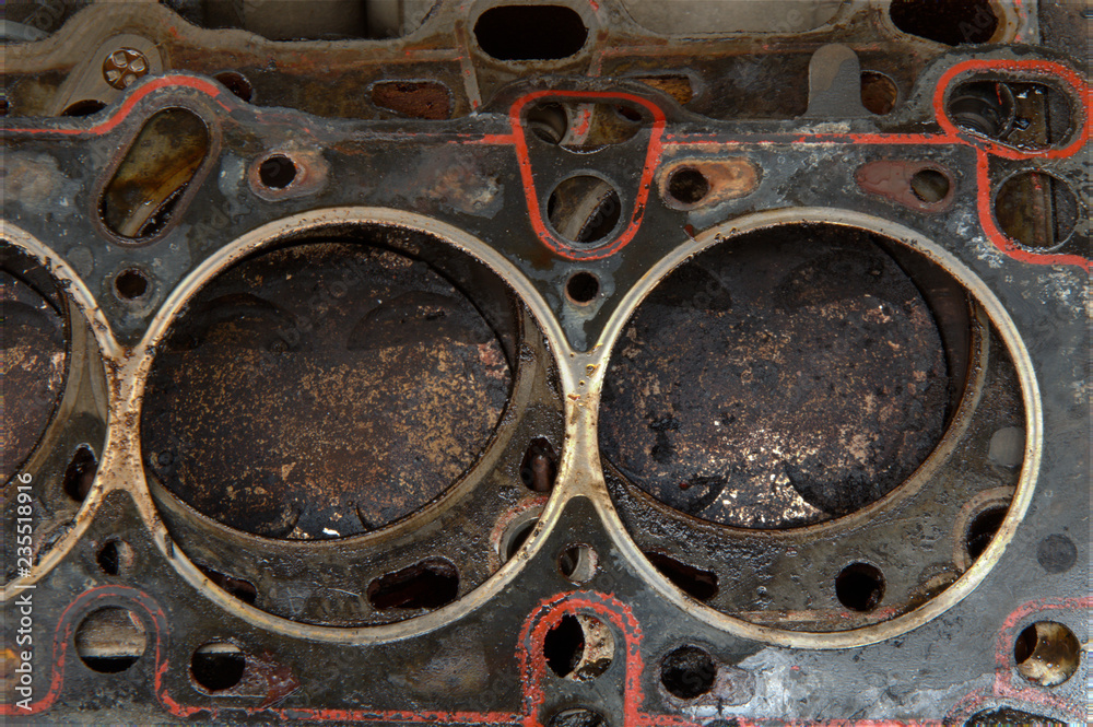Head gasket failure on old car engine details, with carbon deposits and