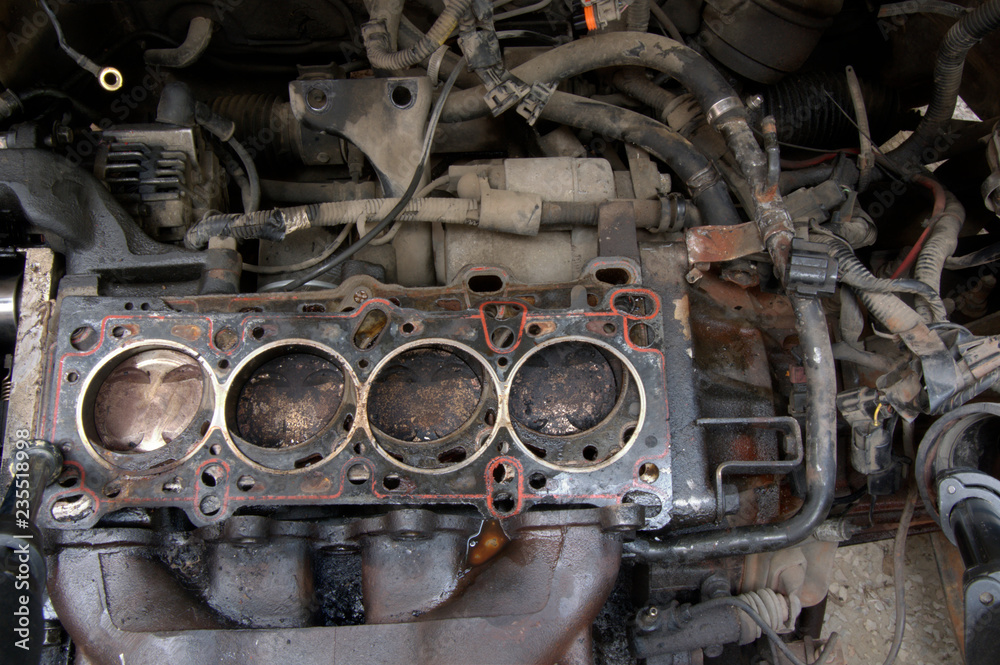 Head gasket failure on old car engine details, with carbon deposits and