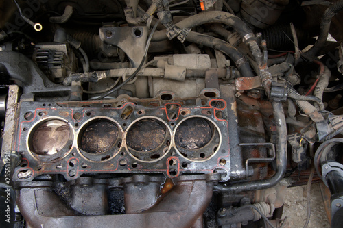 Head gasket failure on old car engine details, with carbon deposits and oil everywhere