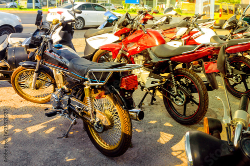 New motorcycles and mopeds exhibited for sale on the street