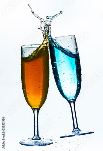 Colorful splash in champagne glass isolated on white background