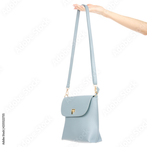 Woman's female blue leather bag in hand pulls out of the bag on white background isolation