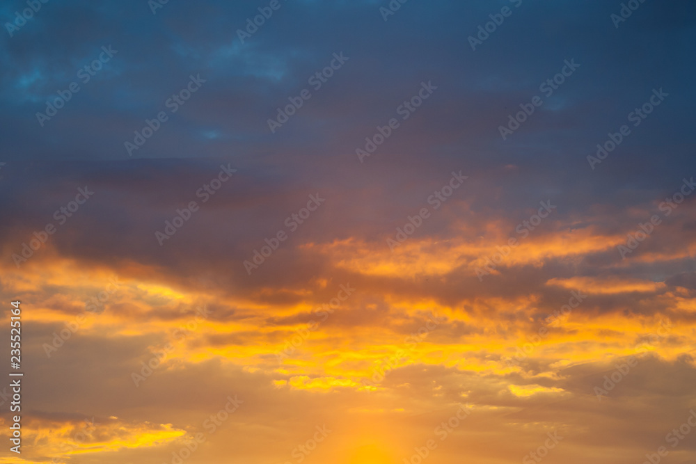 Dramatic view on a orange clouds in sunset sky