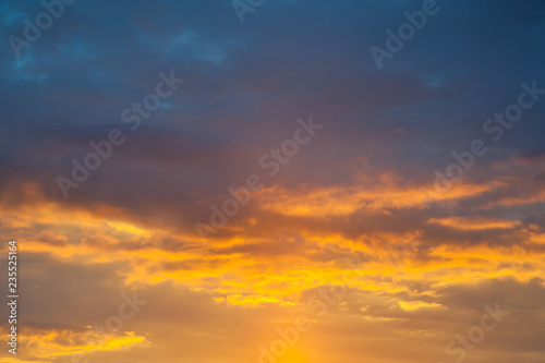Dramatic view on a orange clouds in sunset sky