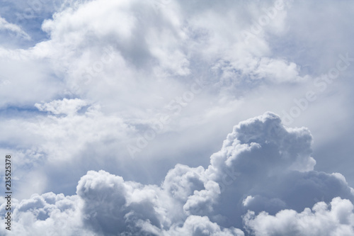 Dramatic view on a gray cumulus fluffy clouds as background (abstract)