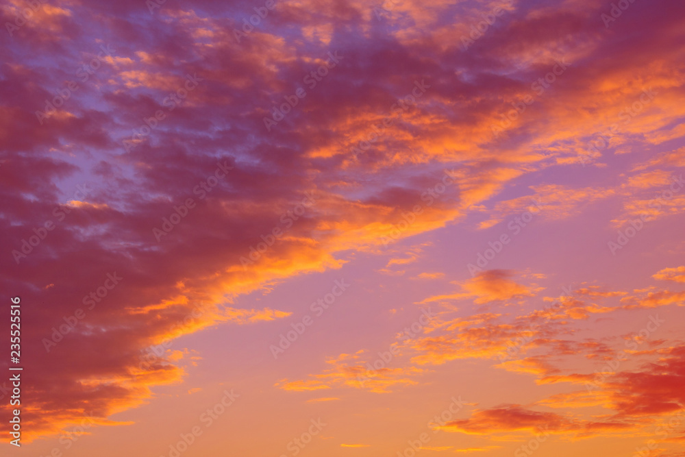 Dramatic view on a orange clouds in the evening sunset sky (background, toned)