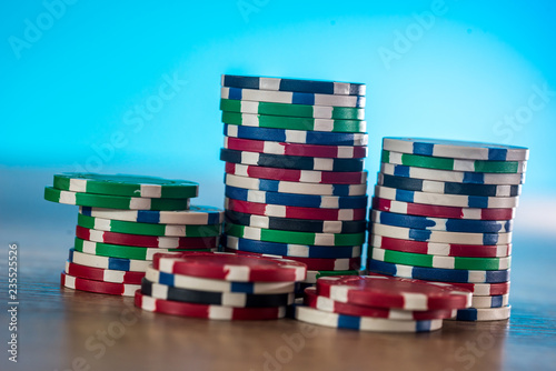 Casino chips on wooden table with blue background