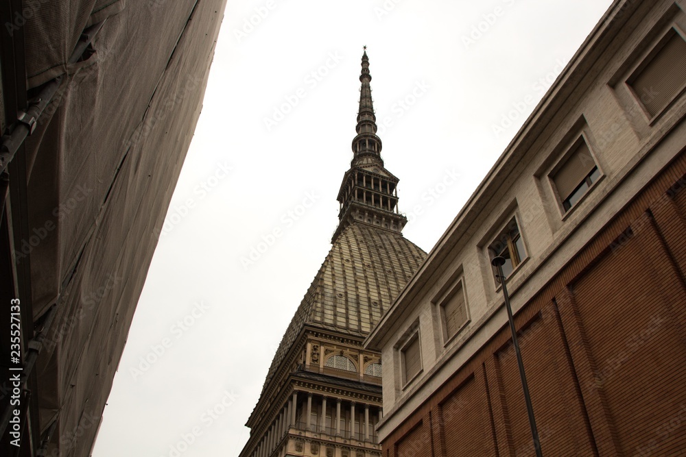 Mole Antonelliana tower in Turin (Torino) town. Rainy, cloudy weather. Turin, Italy.