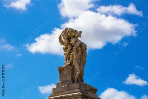 Woman kisses man statue in front of Altar of the Fatherland in Rome. Kissing sculpture in front of the Altare della Patria (Altar of the Fatherland) monument in Piazza Venezia. Rome, Italy.